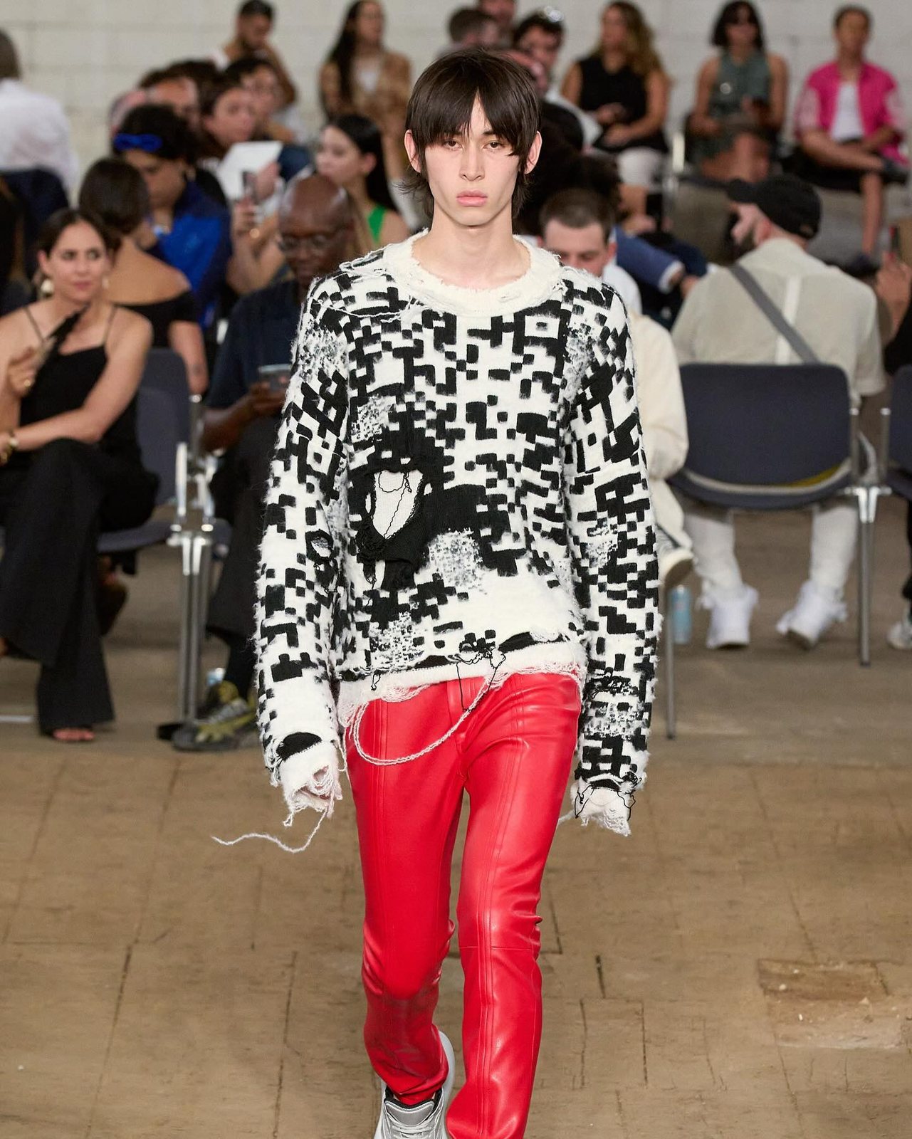 JW Anderson runway model in a black and white knitted jumper